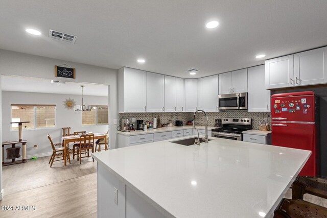 5702 S Beck Ave, Tempe, AZ 85283 - kitchen with visible vents, a sink, light countertops, and stainless steel appliances