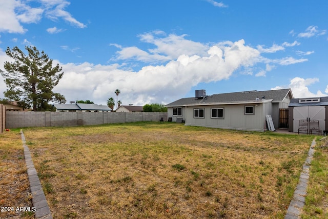 5702 S Beck Ave, Tempe, AZ 85283 - view of yard with an outdoor structure, a fenced backyard, central AC, and a shed