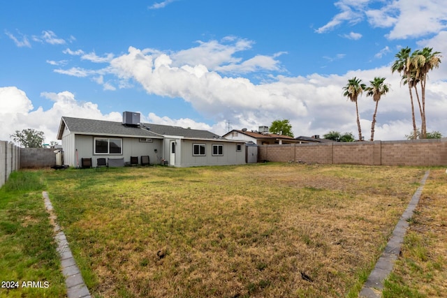 5702 S Beck Ave, Tempe, AZ 85283 - back of property featuring a lawn, central AC, a fenced backyard, and roof with shingles