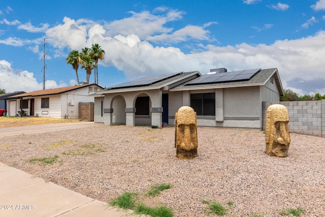 5702 S Beck Ave, Tempe, AZ 85283 - single story home with stucco siding, roof mounted solar panels, and fence
