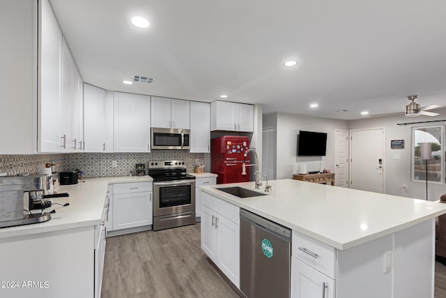 5702 S Beck Ave, Tempe, AZ 85283 - kitchen featuring light countertops, white cabinets, tasteful backsplash, a sink, and stainless steel appliances