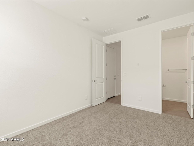 unfurnished bedroom featuring light colored carpet