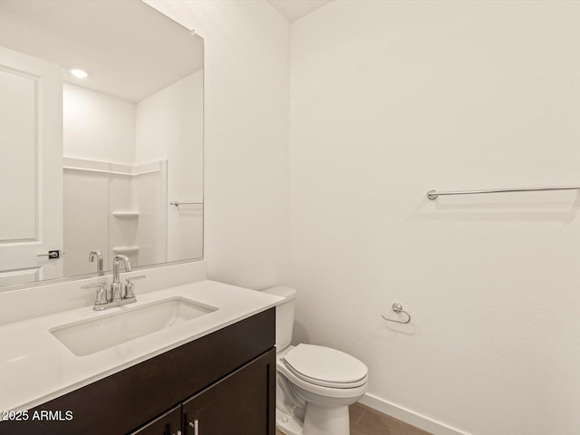 bathroom featuring toilet and vanity