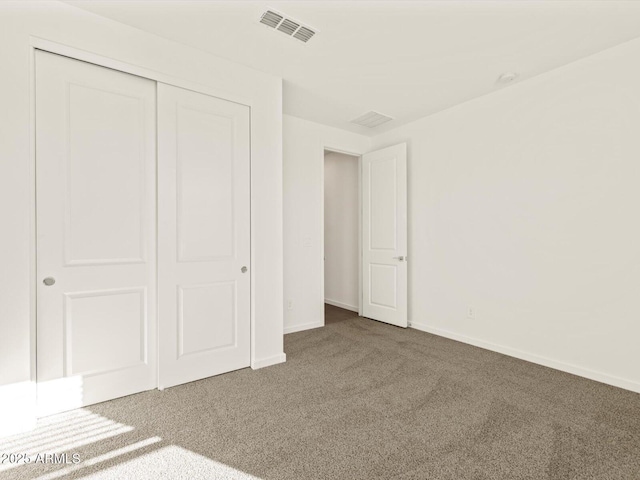 unfurnished bedroom featuring carpet flooring and a closet