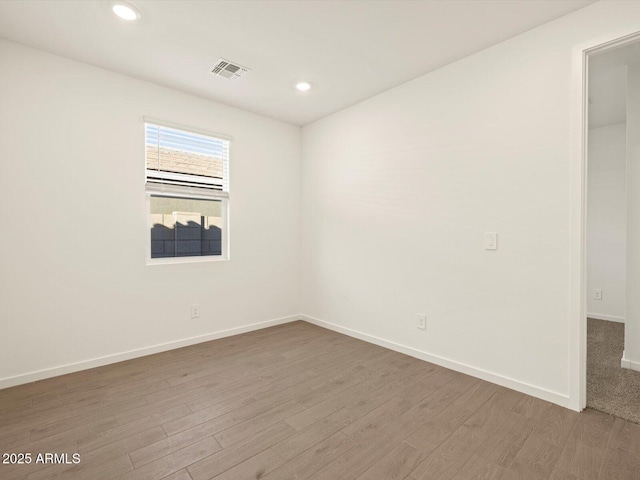 spare room featuring wood-type flooring