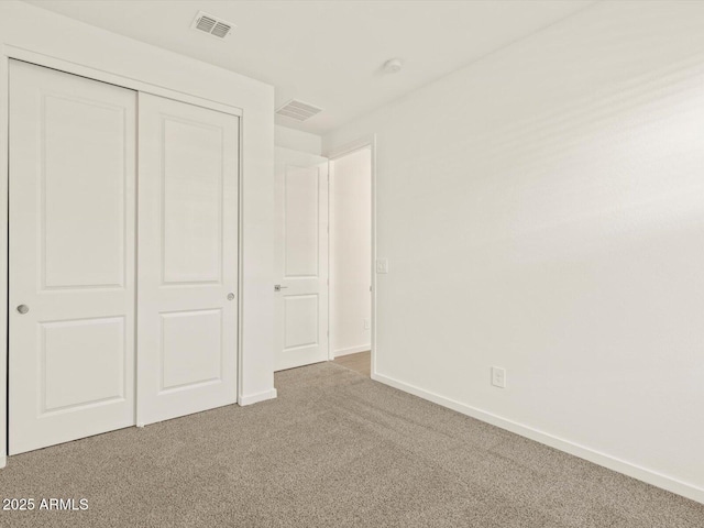 unfurnished bedroom featuring a closet and carpet floors