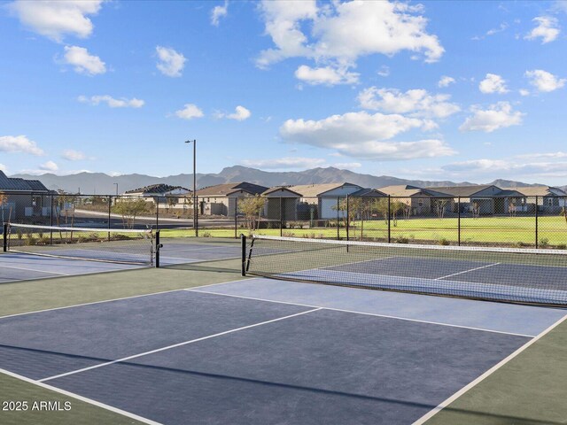 view of tennis court with a mountain view