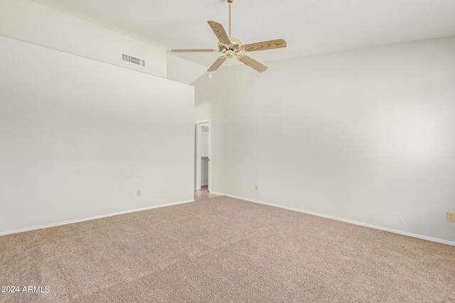 carpeted spare room with ceiling fan and high vaulted ceiling