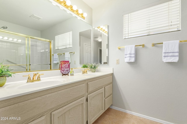 bathroom with vanity, tile patterned flooring, and a shower with door