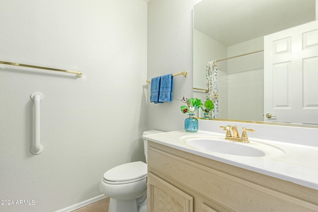 bathroom featuring toilet, curtained shower, and vanity