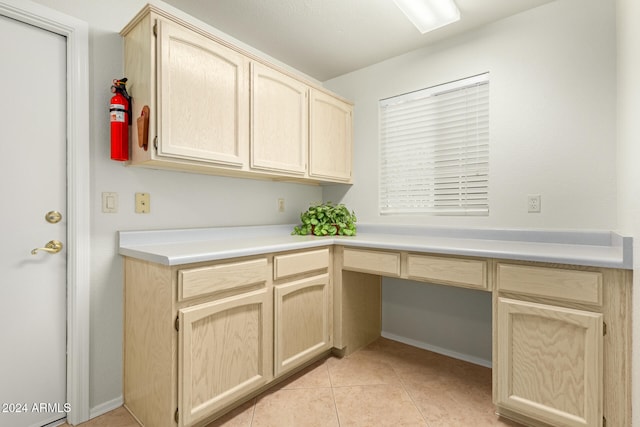 clothes washing area featuring light tile patterned floors