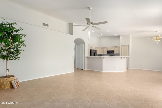 unfurnished living room featuring light tile patterned flooring, high vaulted ceiling, and ceiling fan