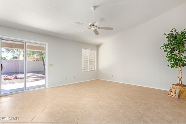 empty room with ceiling fan and light tile patterned floors