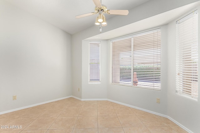 tiled empty room with ceiling fan