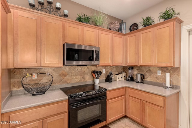 kitchen featuring light tile patterned flooring, backsplash, light brown cabinetry, and black range with electric cooktop