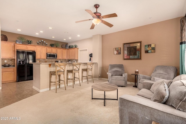 carpeted living room featuring ceiling fan