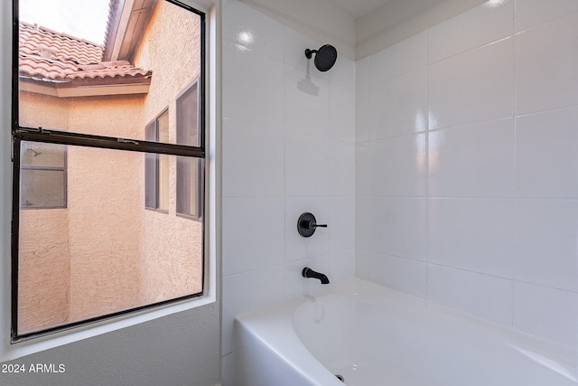 bathroom featuring tiled shower / bath combo and plenty of natural light