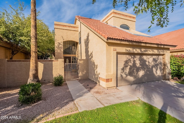 mediterranean / spanish home featuring a garage