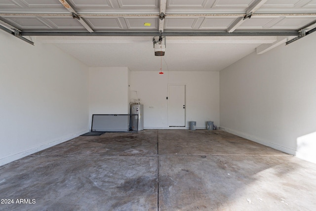 garage with a garage door opener and electric water heater