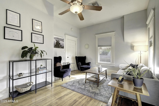 living room with ceiling fan and light wood-type flooring