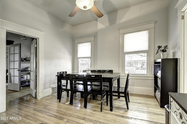 dining room with ceiling fan, a healthy amount of sunlight, and light hardwood / wood-style flooring