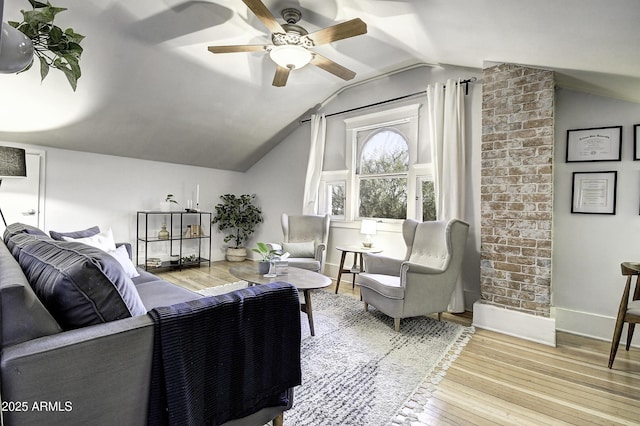 living room with vaulted ceiling, ceiling fan, and light hardwood / wood-style floors