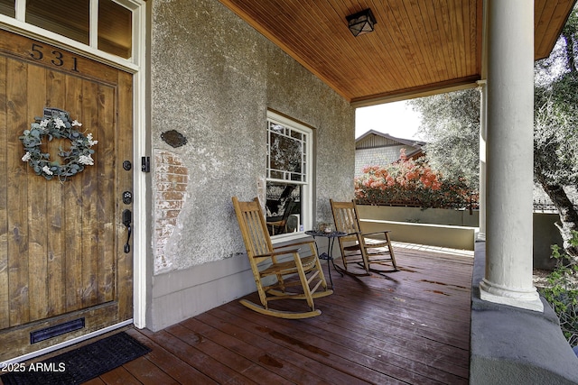 wooden terrace with a porch