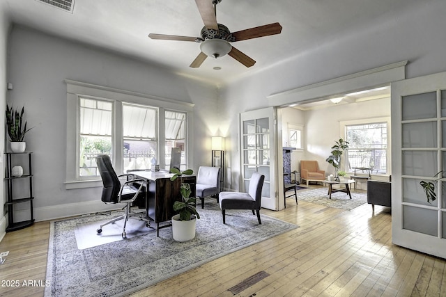 office space with ceiling fan and light hardwood / wood-style floors