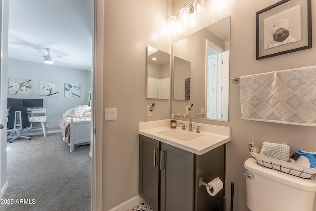 bathroom with ceiling fan, toilet, and vanity