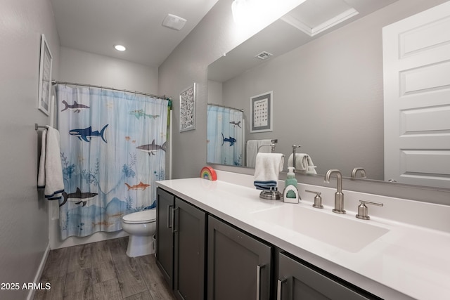 full bathroom featuring toilet, wood-type flooring, vanity, and shower / bath combo with shower curtain