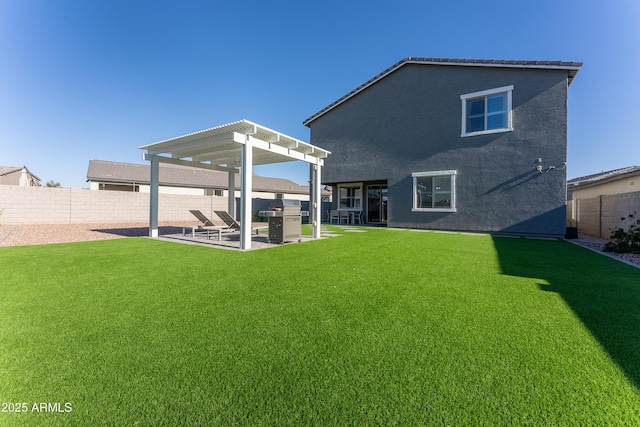 rear view of property with a pergola and a yard