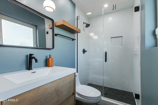 full bathroom with a shower stall, vanity, and toilet