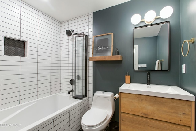 bathroom with tiled shower / bath combo, vanity, and toilet