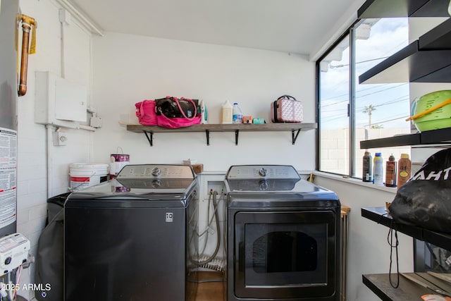 clothes washing area featuring laundry area and separate washer and dryer