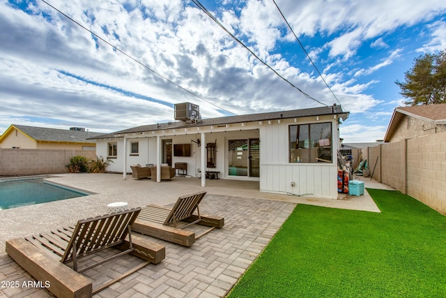 back of house with a patio, a fenced backyard, outdoor lounge area, a fenced in pool, and board and batten siding