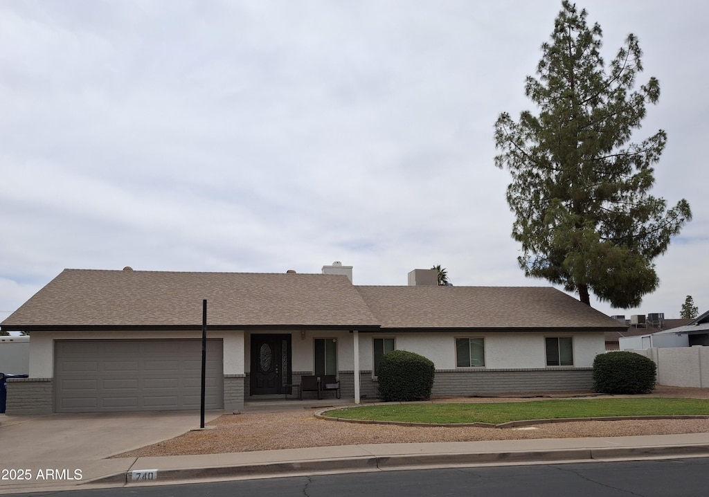740 N Oracle, Mesa, AZ 85203 - ranch-style home featuring concrete driveway, an attached garage, stucco siding, and brick siding