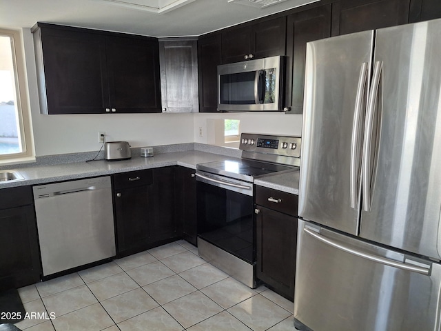 740 N Oracle, Mesa, AZ 85203 - kitchen featuring stainless steel appliances, light tile patterned floors, dark cabinetry, and light countertops