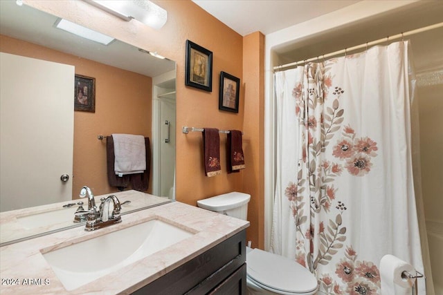 bathroom with vanity, toilet, and a shower with shower curtain