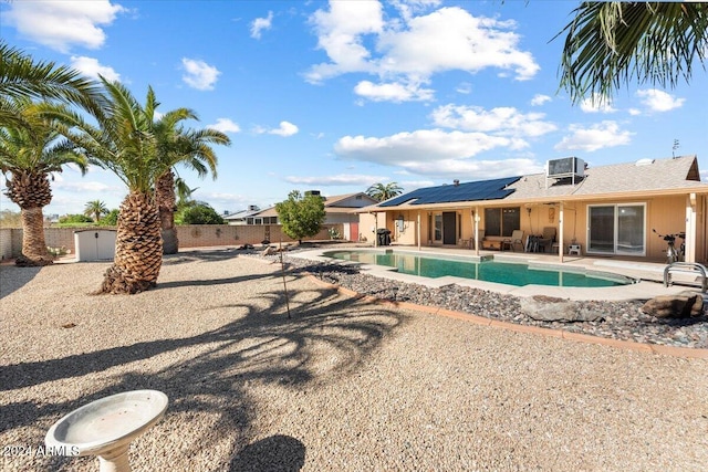 view of swimming pool with central AC unit and a patio