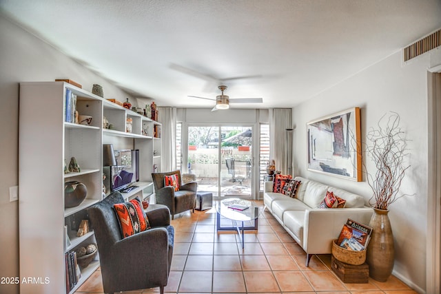 living room with ceiling fan and light tile patterned flooring