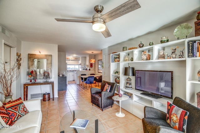 tiled living room with ceiling fan