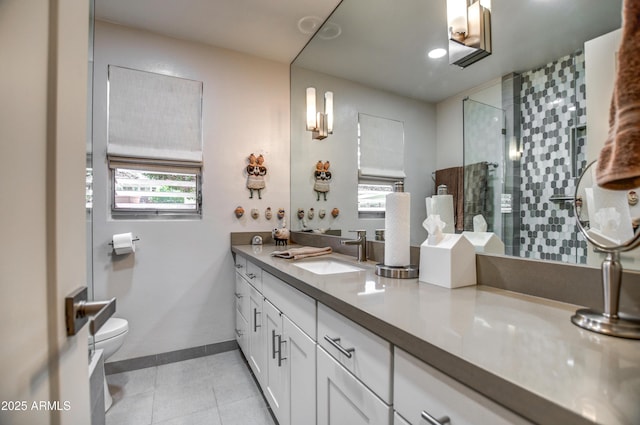 bathroom featuring vanity, toilet, a shower with door, and tile patterned flooring