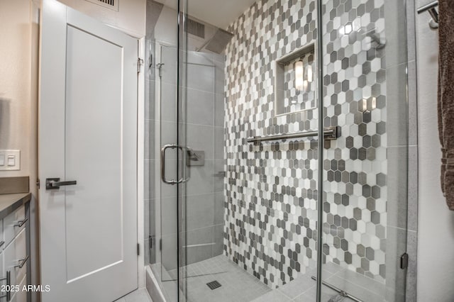 bathroom featuring an enclosed shower and vanity