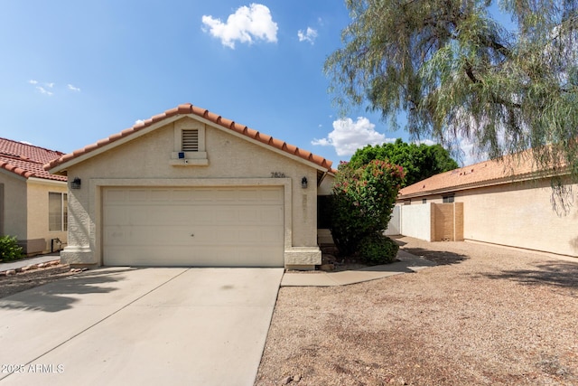 7826 W Mcrae Way, Glendale, AZ 85308 - mediterranean / spanish-style home with a tiled roof, driveway, stucco siding, and an attached garage
