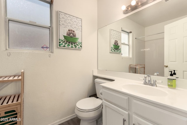 7826 W Mcrae Way, Glendale, AZ 85308 - bathroom featuring toilet, vanity, plenty of natural light, and wood finished floors