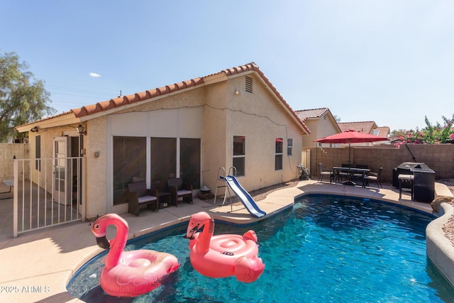 7826 W Mcrae Way, Glendale, AZ 85308 - view of pool with a water slide, a patio, and area for grilling