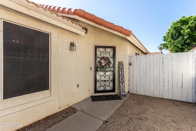 7826 W Mcrae Way, Glendale, AZ 85308 - doorway to property with stucco siding and a tiled roof