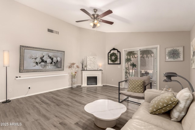 7826 W Mcrae Way, Glendale, AZ 85308 - living area with a ceiling fan, lofted ceiling, wood finished floors, baseboards, and a fireplace