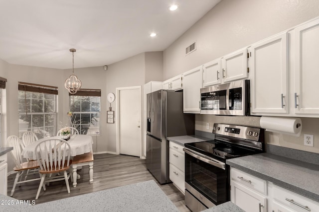 7826 W Mcrae Way, Glendale, AZ 85308 - kitchen featuring appliances with stainless steel finishes, white cabinets, dark countertops, light wood finished floors, and recessed lighting
