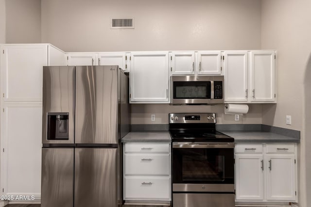 7826 W Mcrae Way, Glendale, AZ 85308 - kitchen with appliances with stainless steel finishes, white cabinets, and dark countertops